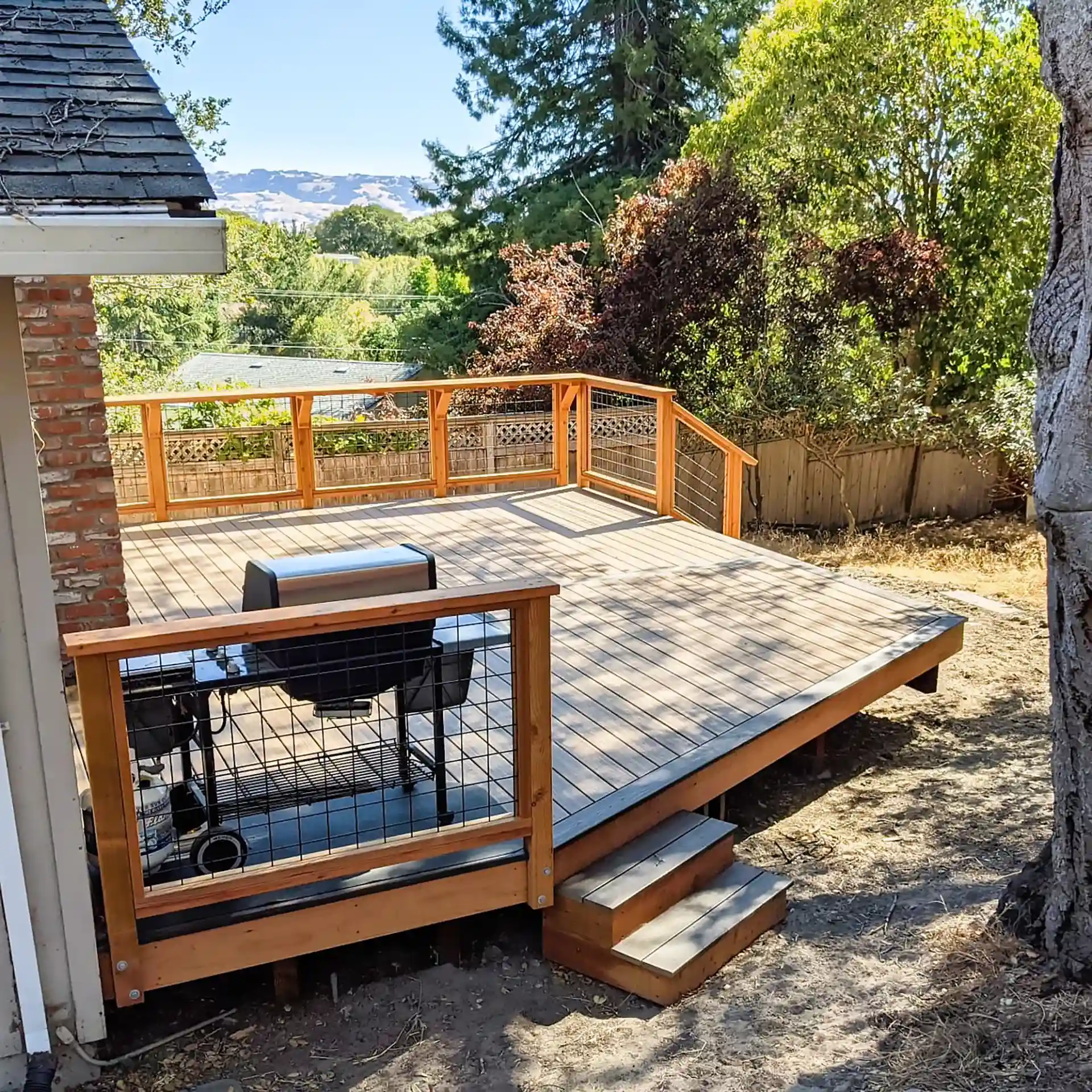 Custom wood deck with cable railings and mountain views